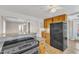 Bright kitchen featuring wood cabinets, black appliances, and an open view into another room at 152 E Tryon St, Hillsborough, NC 27278