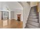 An open-plan living room features a fireplace, hardwood floors and staircase at 152 E Tryon St, Hillsborough, NC 27278