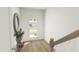 Bright entryway features wood flooring, a stylish door, and a decorative mirror at 173 Shakespeare Dr, Homesite 46, Morrisville, NC 27560