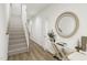 Open hallway with stairs, wood floors, and decorative table with accent mirror at 173 Shakespeare Dr, Homesite 46, Morrisville, NC 27560