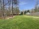 Expansive green backyard featuring an outdoor fire pit and a wooden fence for privacy at 1756 Main Divide Dr, Wake Forest, NC 27587