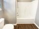Clean bathroom features a white tub/shower combo and vinyl flooring for easy maintenance at 1756 Main Divide Dr, Wake Forest, NC 27587