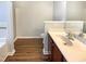 A well-lit bathroom with vinyl flooring, a shower, a toilet, and a vanity area at 1756 Main Divide Dr, Wake Forest, NC 27587