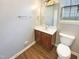 This bathroom includes a single vanity, a mirror, and a toilet with vinyl flooring at 1756 Main Divide Dr, Wake Forest, NC 27587