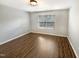Neutral bedroom features a large window and hardwood floors at 1756 Main Divide Dr, Wake Forest, NC 27587