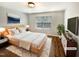 Bright bedroom featuring a comfortable bed, stylish furniture, and neutral decor at 1756 Main Divide Dr, Wake Forest, NC 27587