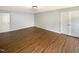 Spacious room featuring hardwood flooring, neutral paint, a lighting fixture, and closet space at 1756 Main Divide Dr, Wake Forest, NC 27587