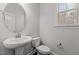 Half bathroom featuring a pedestal sink, toilet, and a window for natural light at 1800 Bodwin Ln, Apex, NC 27502