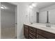 Bathroom with a double sink vanity, dark cabinets, and a large mirror at 1800 Bodwin Ln, Apex, NC 27502