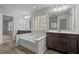 Bright bathroom with a large soaking tub, double vanities, and a window for natural light at 1800 Bodwin Ln, Apex, NC 27502