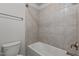 A bathroom features beige tiled walls, a soaking tub, and chrome fixtures at 1800 Bodwin Ln, Apex, NC 27502