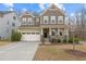 Inviting two-story home with a charming front porch and a two car garage at 1800 Bodwin Ln, Apex, NC 27502