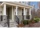 Close up of the front porch area with stone pillars and black iron railings at 1800 Bodwin Ln, Apex, NC 27502