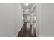 Bright hallway with hardwood floors leading into an open-concept living area at 1800 Bodwin Ln, Apex, NC 27502