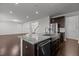 Open-concept kitchen with dark cabinets, stainless steel appliances, and view to living room at 1800 Bodwin Ln, Apex, NC 27502