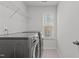 Convenient laundry room equipped with modern appliances and built-in shelving for storage at 1800 Bodwin Ln, Apex, NC 27502