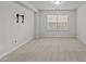 Bright living room with neutral carpet, tv mount and a large window for natural light at 1800 Bodwin Ln, Apex, NC 27502