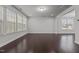 Spacious living room with recessed lighting, hardwood floors and large windows to let the light shine in at 1800 Bodwin Ln, Apex, NC 27502