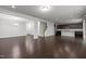 Open-concept view of living room and kitchen, showcasing hardwood floors and modern finishes at 1800 Bodwin Ln, Apex, NC 27502