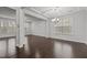 Open-concept living room with coffered ceilings and hardwood floors at 1800 Bodwin Ln, Apex, NC 27502
