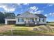 Charming single-story home featuring a covered front porch and attached two-car garage at 186 N Movado Trl, Kenly, NC 27542