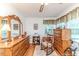 Spacious bedroom with a vintage-style vanity, rocking chair, and hardwood floors at 201 Colonial Ave, Goldston, NC 27252