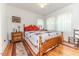 Comfortable bedroom with a patterned quilt, two nightstands, and a ceiling fan at 201 Colonial Ave, Goldston, NC 27252