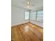 Bright bedroom with hardwood floors, white walls, and natural light from two windows at 201 Colonial Ave, Goldston, NC 27252