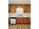 Functional kitchen with double basin sink, wood cabinets, and essential appliances at 201 Colonial Ave, Goldston, NC 27252
