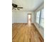 Inviting room features hardwood floors, paneled ceilings, fan and bright natural light at 201 Colonial Ave, Goldston, NC 27252