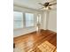 Sunlit living room with hardwood floors and two windows providing natural light at 201 Colonial Ave, Goldston, NC 27252