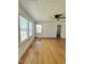 Bright room featuring hardwood floors, paneled ceilings, fan and bright natural light at 201 Colonial Ave, Goldston, NC 27252