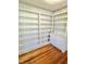 Floor to ceiling shelving unit with lower storage cabinets on hardwood floors at 201 Colonial Ave, Goldston, NC 27252