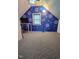 Quirky attic room with blue walls with butterfly stencils and neutral carpeting at 214 Grace St, Oxford, NC 27565