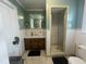 Bathroom featuring a walk-in shower, updated vanity, and neutral tiles at 214 Grace St, Oxford, NC 27565