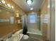 Traditional bathroom featuring a shower/tub combo, neutral paint and a window for natural light at 214 Grace St, Oxford, NC 27565