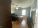 Bedroom features hardwood floors, ceiling fan, and natural light from the large window at 214 Grace St, Oxford, NC 27565