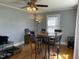 Cozy dining room with wood floors, ceiling fan, and a round table with four chairs at 214 Grace St, Oxford, NC 27565