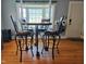 Dining room featuring wood floors, a bay window, and a modern table and chairs at 214 Grace St, Oxford, NC 27565