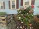 Charming home exterior with blue siding and colorful flowering bushes at 214 Grace St, Oxford, NC 27565