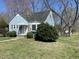 Quaint blue home with a well-kept lawn and mature trees at 214 Grace St, Oxford, NC 27565