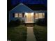 Charming single-story home featuring a welcoming front porch and manicured lawn at 214 Grace St, Oxford, NC 27565