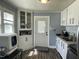Functional kitchen featuring white cabinets, ample counter space, and essential appliances at 214 Grace St, Oxford, NC 27565