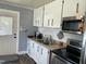 The kitchen provides stainless steel appliances, light countertops, and clean white cabinetry at 214 Grace St, Oxford, NC 27565