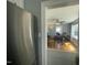 View from the kitchen with stainless steel refrigerator and sightlines to the nearby dining room at 214 Grace St, Oxford, NC 27565