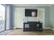 Cozy living room with a television set, cabinet, and access to a balcony at 214 Grace St, Oxford, NC 27565