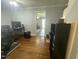 Open living room featuring hardwood floors, a view into another room, and adequate natural light at 214 Grace St, Oxford, NC 27565