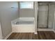A bathroom with a soaking tub and glass-enclosed shower at 22 Wynd Crest Way, Benson, NC 27504