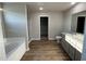 A stylish bathroom featuring a soaking tub, a walk-in shower, and wood-look floors at 22 Wynd Crest Way, Benson, NC 27504