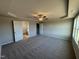 A roomy bedroom boasting neutral walls, plush carpet, and a stylish ceiling fan at 22 Wynd Crest Way, Benson, NC 27504